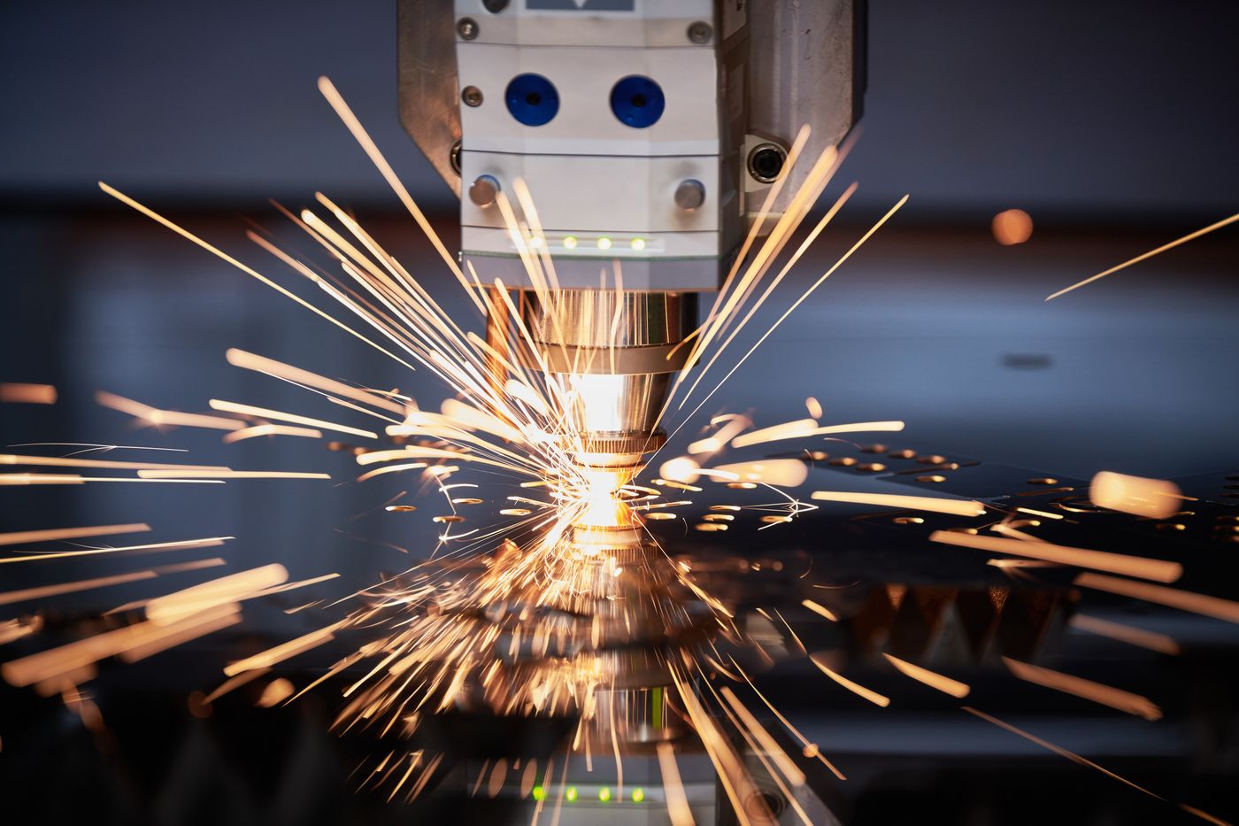 Laser cutter cutting sheet metal with sparks