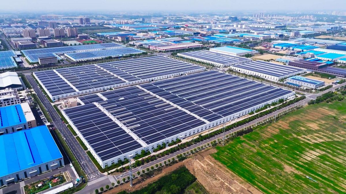 Aerial view of factory rooftops covered with solar panels